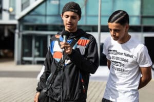 Ali and Hicham speaking during the memorial for Nahel in Nanterr idir hakim photographe paris
