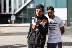 Ali and Hicham speaking during the memorial for Nahel in Nanterr idir hakim photographe paris