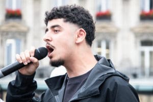 Young Palestinian activist leads chants during Paris rally for G idir hakim photographe paris