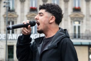 Young Palestinian activist leads chants during Paris rally for G idir hakim photographe paris